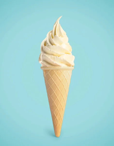 Tasty vanilla ice cream in waffle cone on pastel light blue background. Soft serve