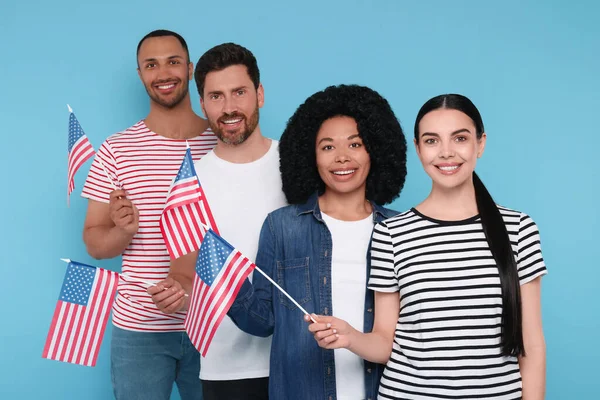 stock image 4th of July - Independence Day of USA. Happy friends with American flags on light blue background
