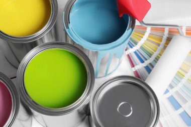 Cans of paints, roller and palette on white background, above view clipart