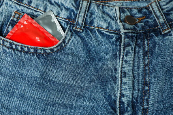 Packaged condoms in jeans pocket, closeup. Safe sex