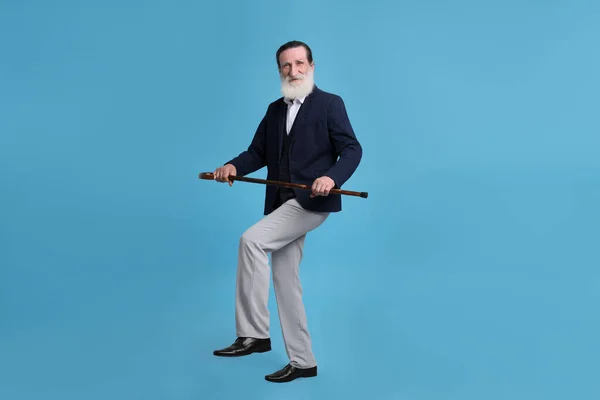 Homem Sênior Com Bengala Andando Fundo Azul Claro — Fotografia de Stock