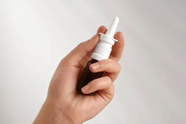 Stock image Woman with nasal spray on white background, closeup