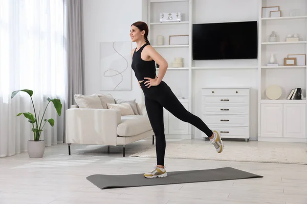 stock image Happy woman doing morning exercise at home