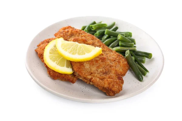 stock image Plate of tasty schnitzels with lemon and green beans isolated on white