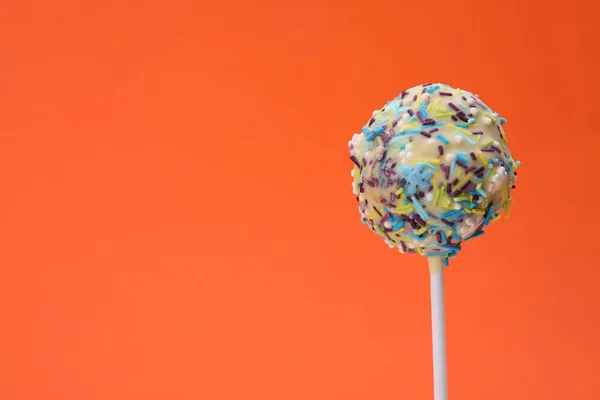 Delicious Confectionery Sweet Cake Pop Decorated Sprinkles Orange Background Closeup — Stock Photo, Image