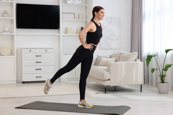 stock image Happy woman doing morning exercise at home