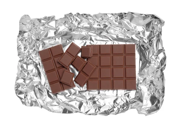 Stock image Pieces of delicious milk chocolate bars with foil isolated on white, top view