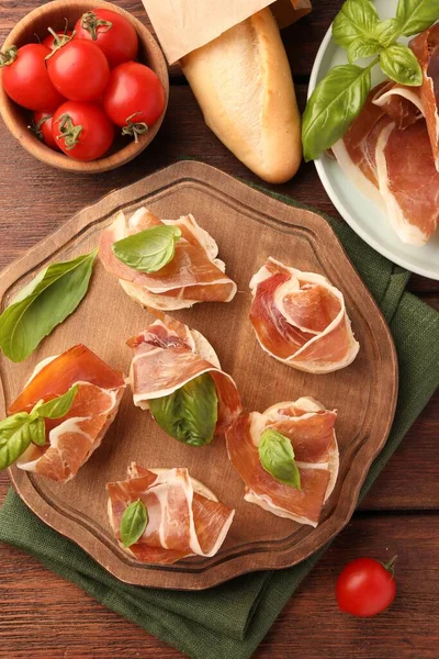 Board Tasty Sandwiches Cured Ham Basil Leaves Tomatoes Wooden Table — Stock Photo, Image
