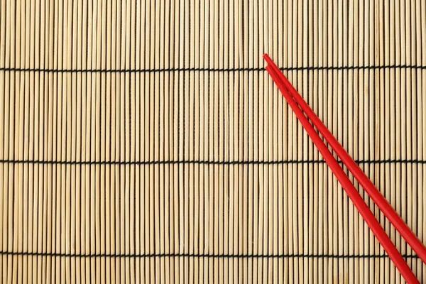 Pair Red Chopsticks Bamboo Mat Top View Space Text — Stock Photo, Image