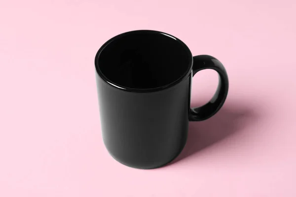 ピンクの背景に黒のセラミックマグカップ1つ — ストック写真