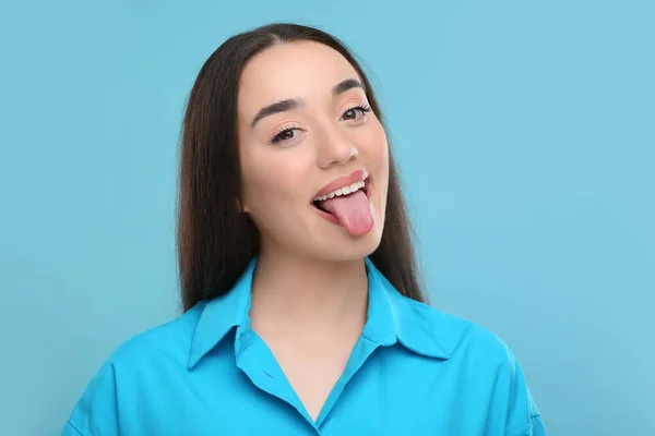 Happy Woman Showing Her Tongue Light Blue Background — Stock Photo, Image
