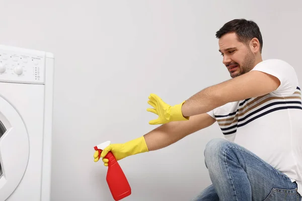 Emotional Man Rubber Gloves Cleaning Wall Sprayer Indoors — Stock Photo, Image