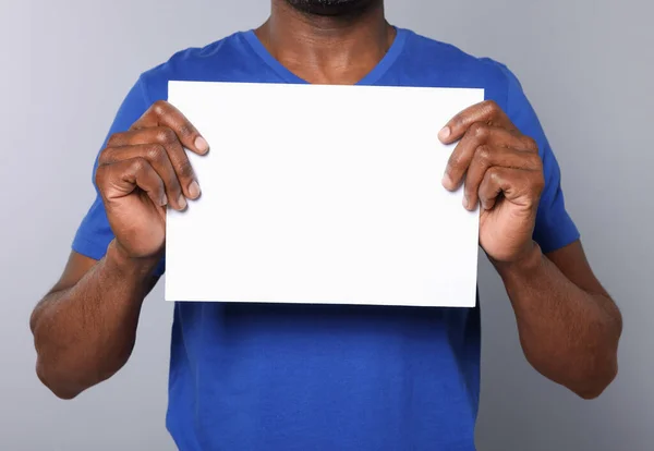 African American Man Holding Sheet Paper Grey Background Closeup Mockup —  Fotos de Stock