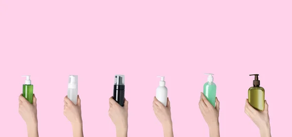 Face and body wash. Women holding bottles of different cosmetic products on pink background, closeup. Collage design with space for text