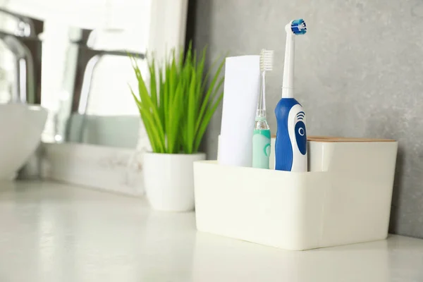Electric Toothbrushes Tube Paste White Countertop Bathroom Space Text — Stock Photo, Image