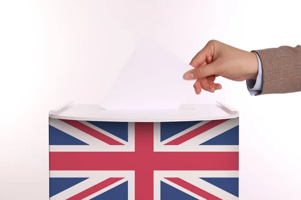 stock image Woman putting her vote into ballot box decorated with flag of United Kingdom against white background, closeup