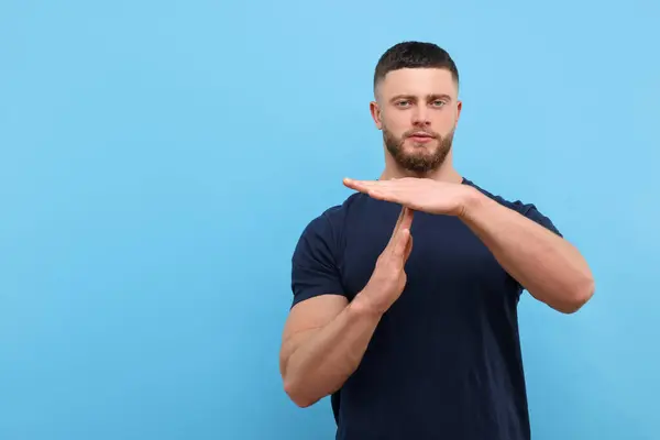 Man Showing Time Out Gesture Light Blue Background Space Text — Stock Photo, Image