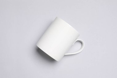 One white ceramic mug on light background, top view