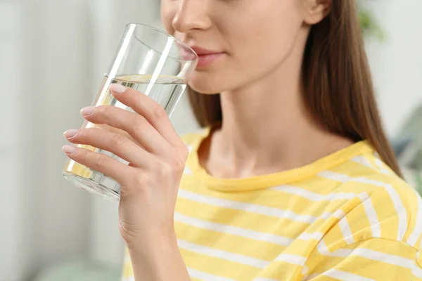 Healthy habit. Closeup of woman drinking fresh water from glass indoors
