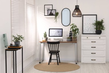 Cozy workspace with computer on wooden desk at home