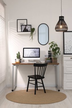 Cozy workspace with computer on wooden desk at home
