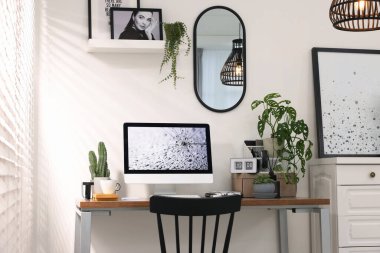 Cozy workspace with computer on wooden desk at home