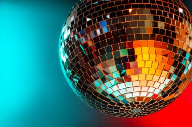 Shiny disco ball under color lights, closeup. Space for text clipart