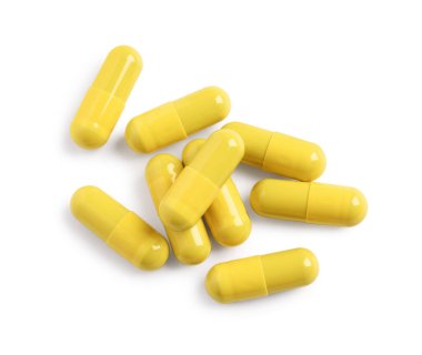 Birçok sarı hap beyaz, üst görünümde izole