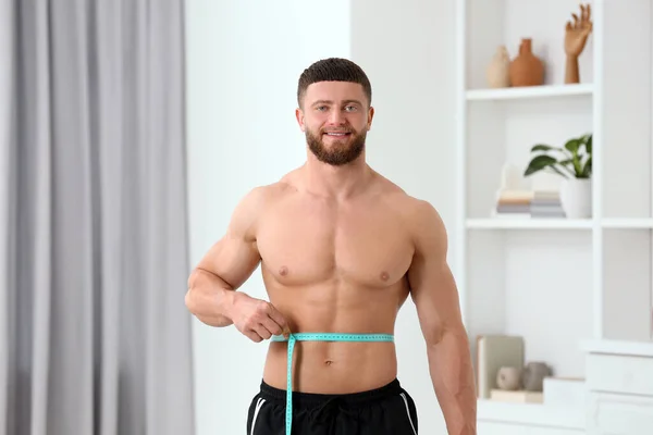 一个快乐的运动员在家里用带子测量腰围的画像 体重减轻概念 — 图库照片