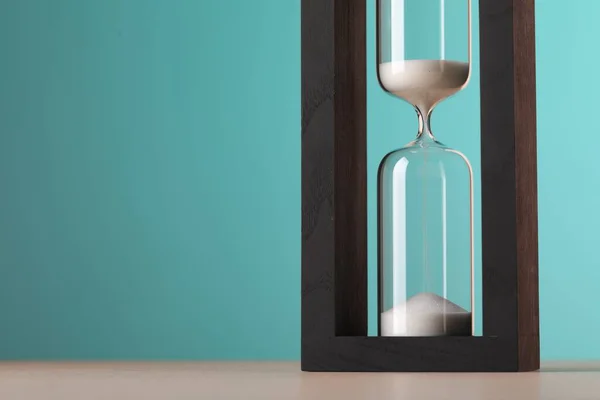 Timglas Med Rinnande Sand Bordet Mot Ljusblå Bakgrund Utrymme För — Stockfoto