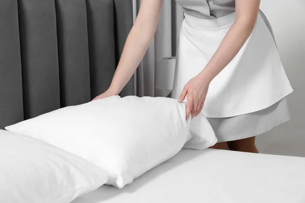 stock image Maid making bed in hotel room, closeup