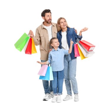 Aile alışverişi. Beyaz arka planda bir sürü renkli çantası olan mutlu anne ve baba ve kız.