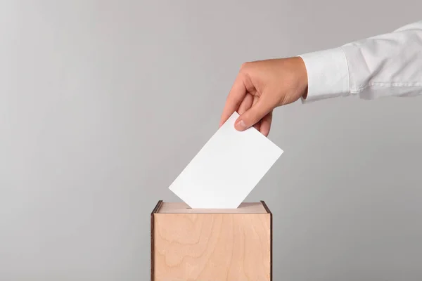 Man Putting His Vote Ballot Box Light Grey Background Closeup — Stock Photo, Image