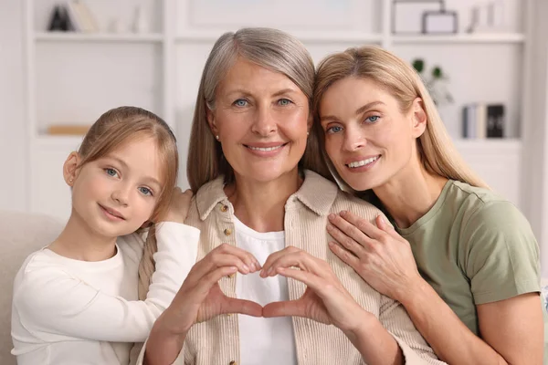 Three Generations Happy Grandmother Showing Heart Gesture Her Daughter Granddaughter — Stock Photo, Image