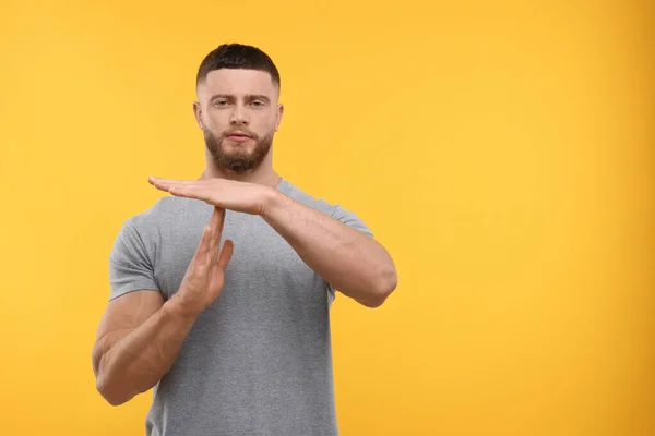 Man Showing Time Out Gesture Orange Background Space Text — Stock Photo, Image