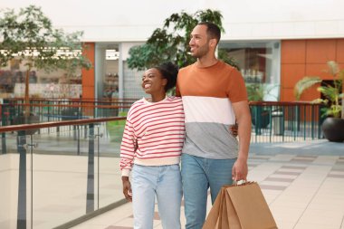 Family shopping. Happy couple with purchases in mall