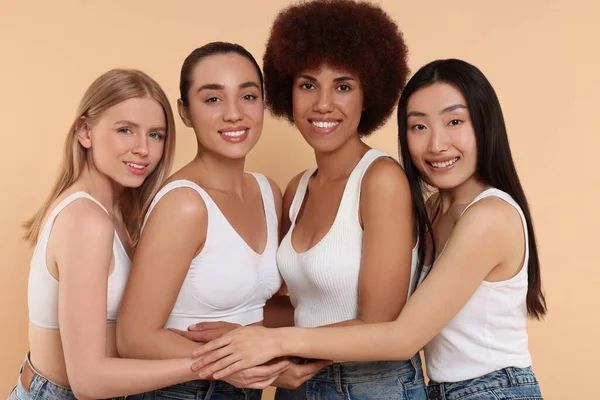 Foto de Group of women with different body types in jeans and underwear on  beige background do Stock