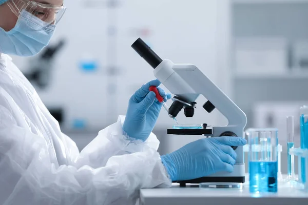 Jovem Cientista Pingando Amostra Placa Petri Enquanto Trabalhava Com Microscópio — Fotografia de Stock