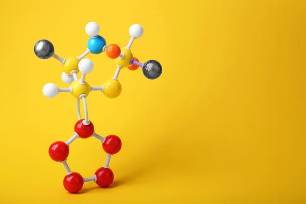 stock image Structure of molecule on yellow background, space for text. Chemical model