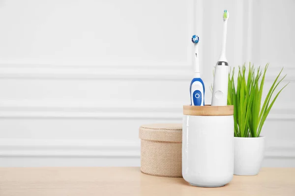 Electric Toothbrushes Holder Wooden Table Space Text — Stock Photo, Image