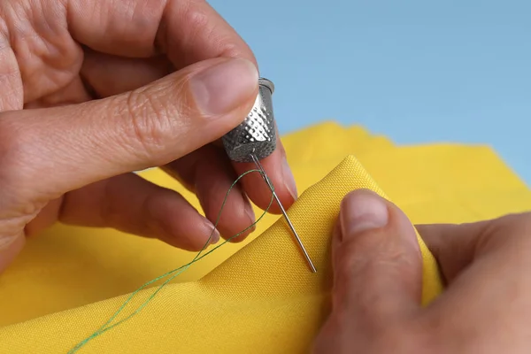 Woman Sewing Yellow Cloth Thimble Needle Light Blue Background Closeup — Stock Photo, Image