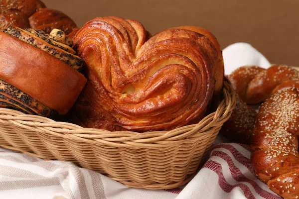 Wicker Basket Different Tasty Freshly Baked Pastries Tablecloth Closeup — Stock Photo, Image