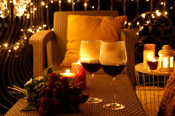 Bouquet Roses Glasses Wine Burning Candles Rattan Table Balcony Night — Stock Photo, Image
