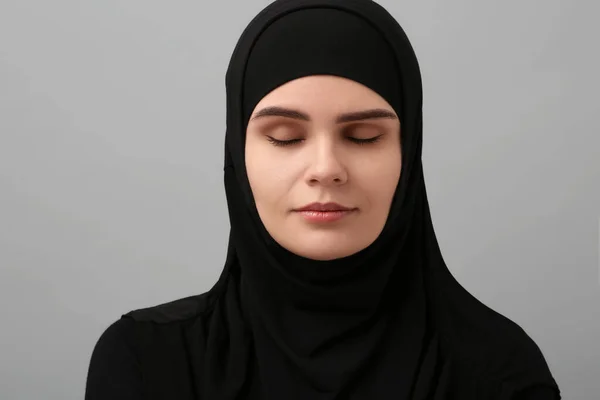 stock image Portrait of Muslim woman in hijab on light gray background