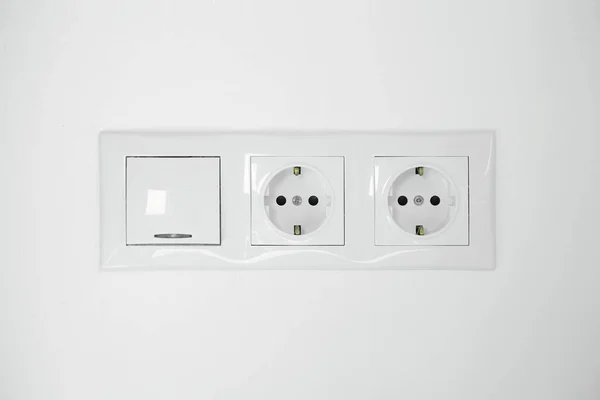 室内白墙上的电灯开关和电源插座 — 图库照片