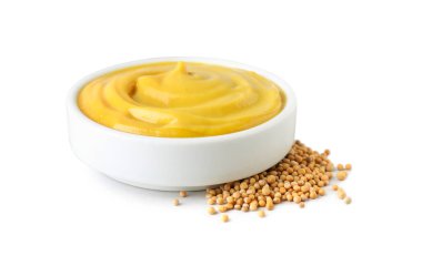 Bowl with delicious mustard and seeds on white background clipart
