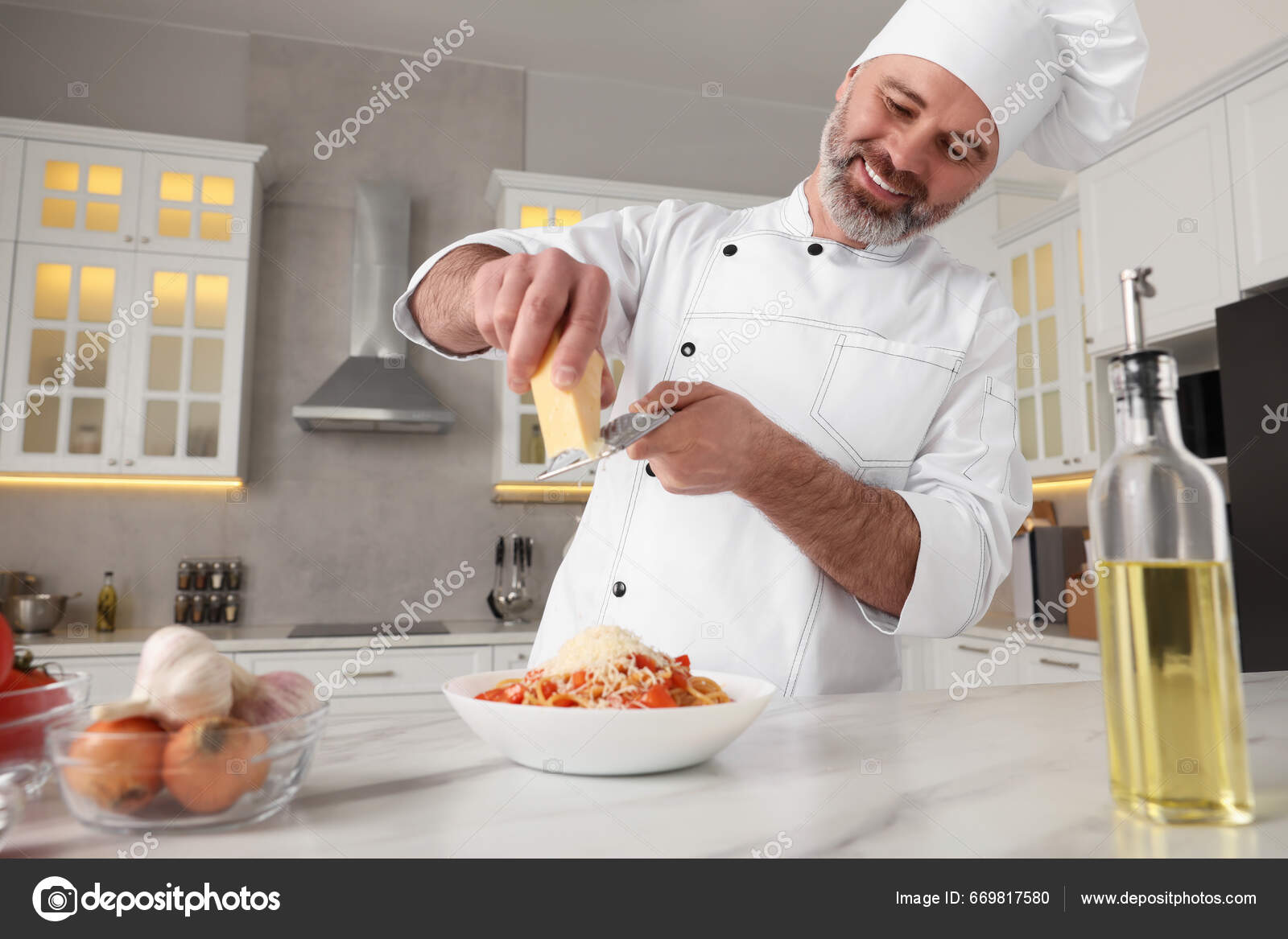 Cheese Beeing Grated In The Kitchen Stock Photo - Download Image