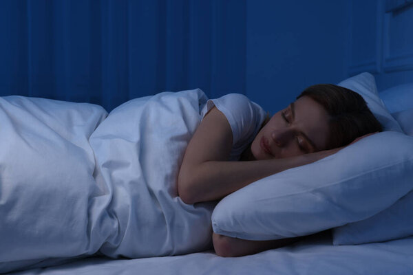 Beautiful woman sleeping in bed at night