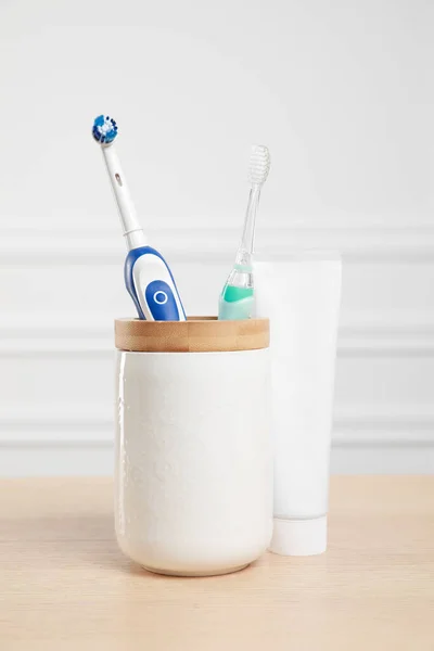 Electric Toothbrushes Tube Paste Wooden Table — Stock Photo, Image