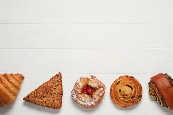 Different Tasty Freshly Baked Pastries White Wooden Table Flat Lay — Stock Photo, Image
